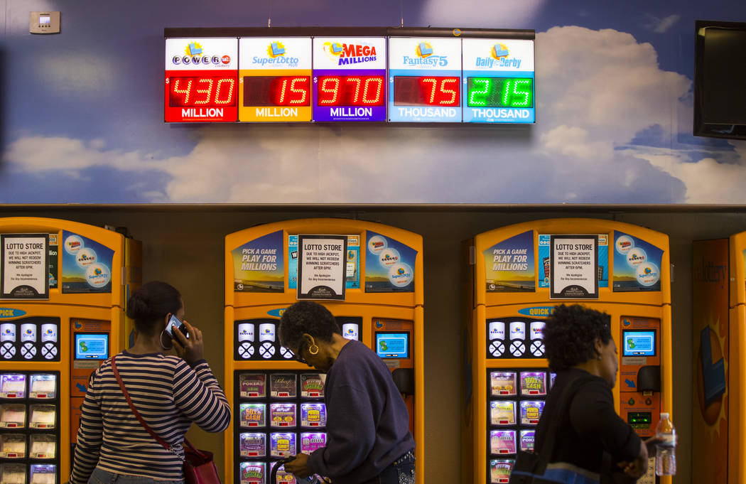Lottery jackpots are digitally displayed at the Primm Valley Lotto Store as people wait to buy the Mega Millions lottery tickets in Primm on Thursday, Oct. 18, 2018. Chase Stevens Las Vegas Review ...