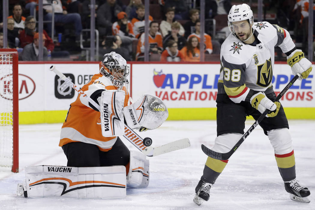 Philadelphia Flyers' Petr Mrazek, left, blocks a shot as Vegas Golden Knights' Tomas Hyka looks on during the third period of an NHL hockey game, Monday, March 12, 2018, in Philadelphia. (AP Photo ...