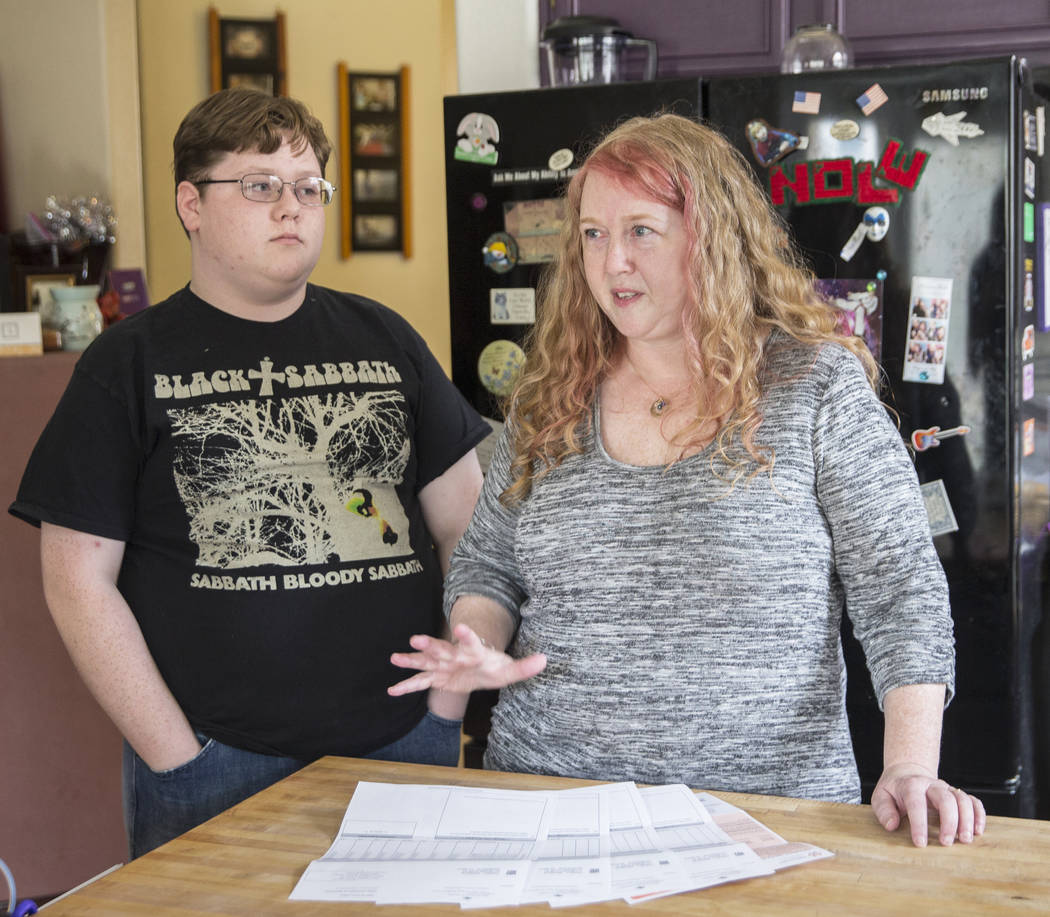 Diane Parnell, right, and son Brandon, 15, discuss issues related to a medical bill they received after a recent visit to an emergency room on Wednesday, Aug. 29, 2018, at Parnell's home, in Hende ...