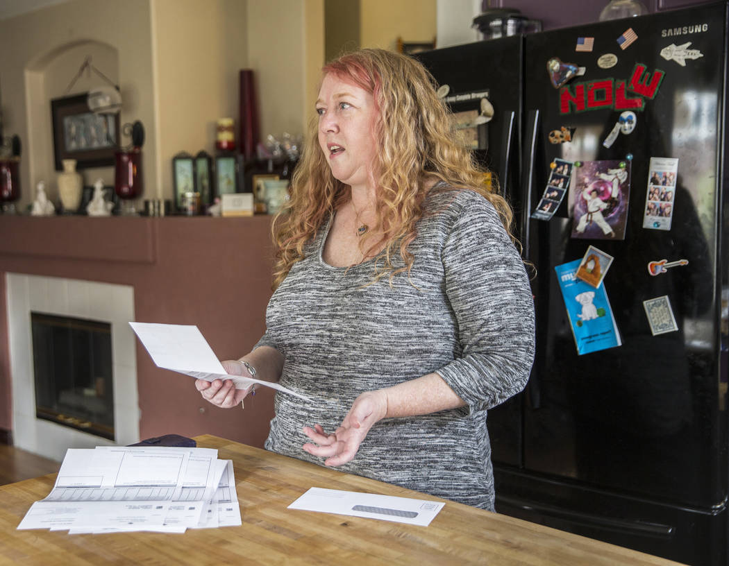 Diane Parnell discusses issues related to a medical bill she received after her son Brandon's recent visit to an emergency room on Wednesday, Aug. 29, 2018, at Parnell's home, in Henderson. Benjam ...