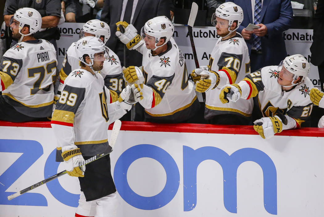 Vegas Golden Knights right wing Alex Tuch (89) celebrates a goal against the Colorado Avalanche with teammates on the bench during the second period of a preseason NHL hockey game Tuesday, Sept. 1 ...