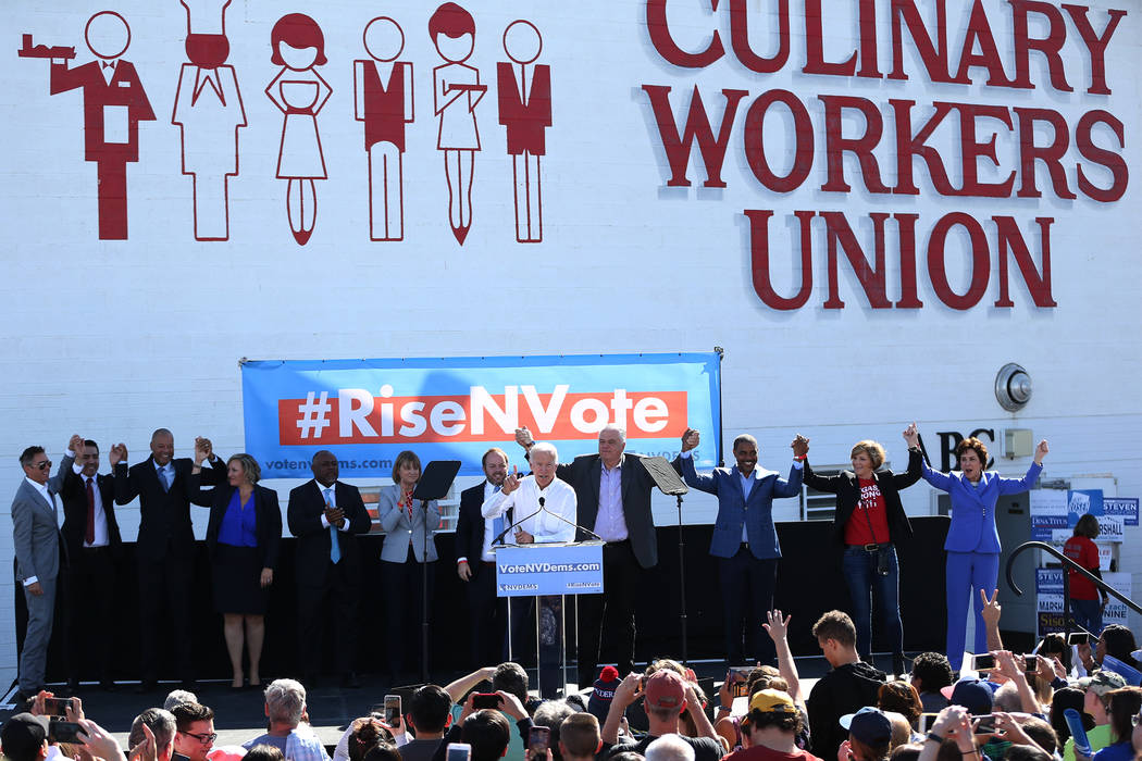 Former Vice President Joe Biden, center, with Nevada democratic candidates, rallies the crowd during a Nevada State Democratic Party rally to promote voting at the Culinary Workers Union Local 226 ...