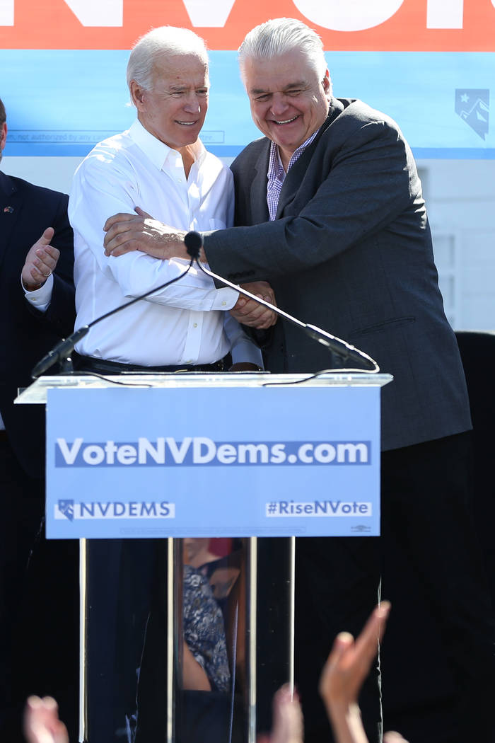 Former Vice President Joe Biden, left, and Clark County Commissioner Steve Sisolak, embrace during a Nevada State Democratic Party rally to promote voting at the Culinary Workers Union Local 226 h ...