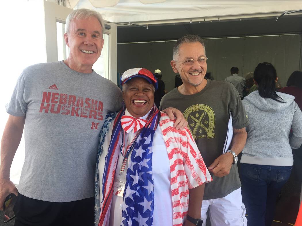 Voters Kevin Kean, left, poll worker Clarice Watkins and David Mecey celebrate the first day of early voting outside the Downtown Summerlin voting site Saturday morning. Marian Green/ Las Vegas Re ...