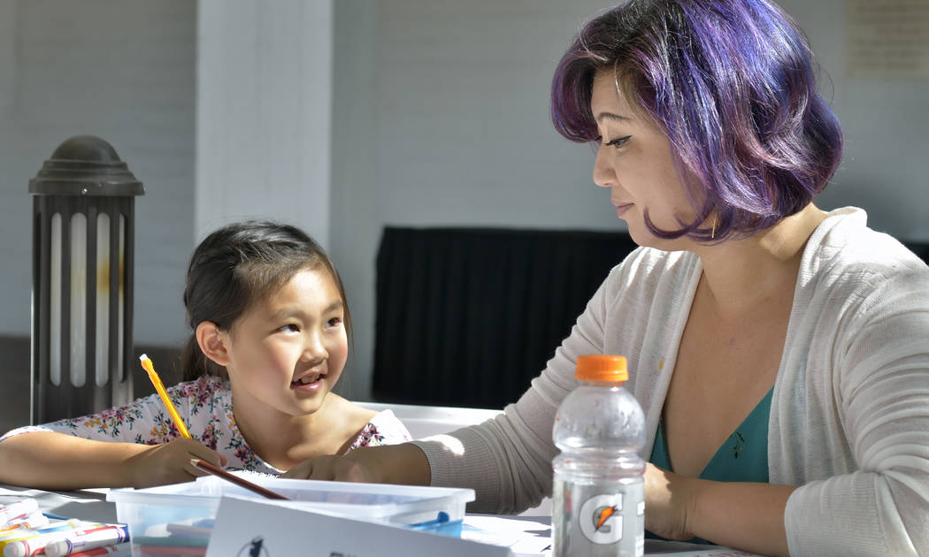 Evelyn Lee, 8, and her mother Linda draw in the Nevada Humanities tent at the Las Vegas Book Festival at the Historic Fifth Street School at 401 S. 4th St. in Las Vegas on Saturday, Oct. 20, 2018. ...
