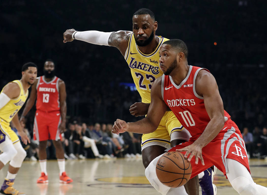Los Angeles Lakers' LeBron James (23) defends on Houston Rockets' Eric Gordon (10) during the first half of an NBA basketball game Saturday, Oct. 20, 2018, in Los Angeles. (AP Photo/Marcio Jose Sa ...