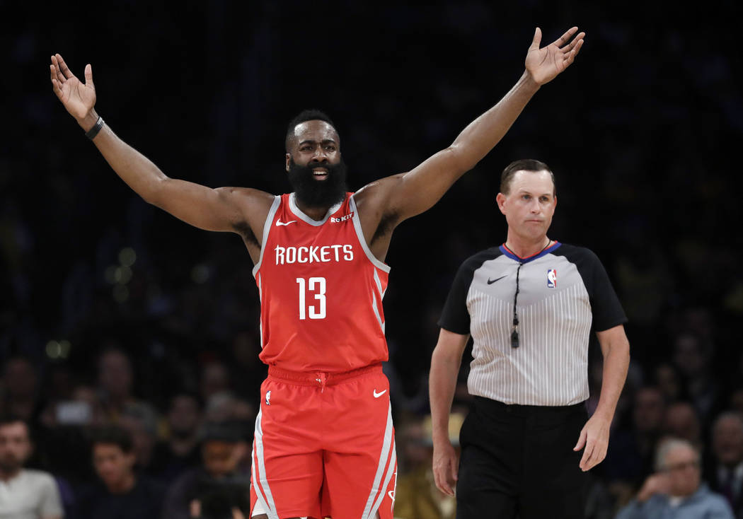 Houston Rockets' James Harden (13) raises his arms after a fouled is called against the Rockets during the first half of an NBA basketball game against the Los Angeles Lakers Saturday, Oct. 20, 20 ...
