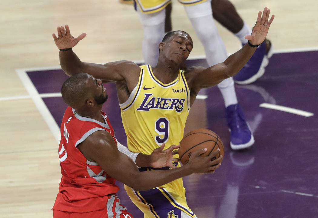 Los Angeles Lakers' Rajon Rondo (9) defends on Houston Rockets' Chris Paul during the first half of an NBA basketball game Saturday, Oct. 20, 2018, in Los Angeles. (AP Photo/Marcio Jose Sanchez)