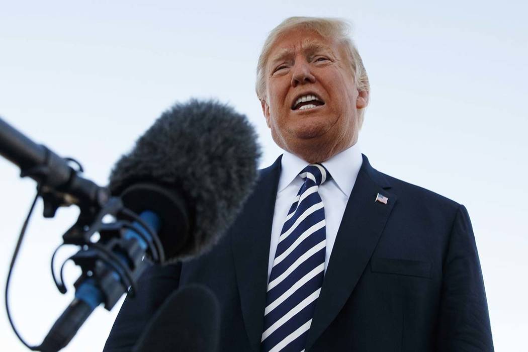 President Donald Trump speaks to media before boarding Air Force One at Elko Regional Airport, Saturday, Oct. 20, 2018, in Elko, after a campaign rally. (AP Photo/Carolyn Kaster)