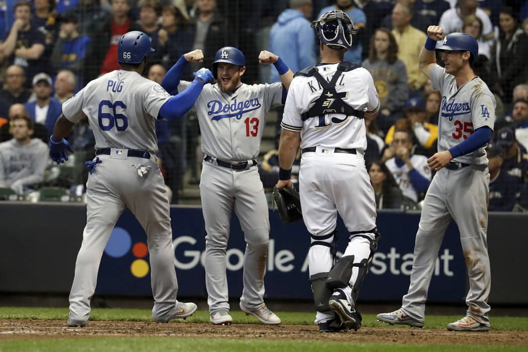 Los Angeles Dodgers' Yasiel Puig (66) celebrates with Max Muncy (13) and Cody Bellinger (35) after hitting a three-run home run during the sixth inning of Game 7 of the National League Championshi ...
