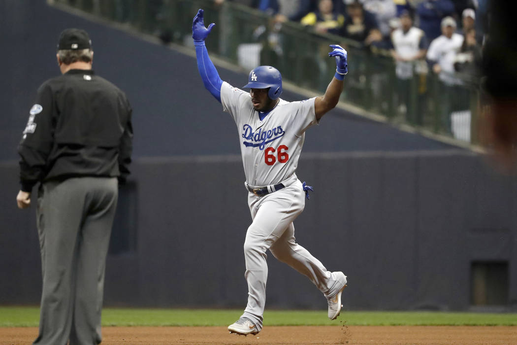 Los Angeles Dodgers' Yasiel Puig (66) celebrates as he runs bases after hitting a three-run home run during the sixth inning of Game 7 of the National League Championship Series baseball game agai ...