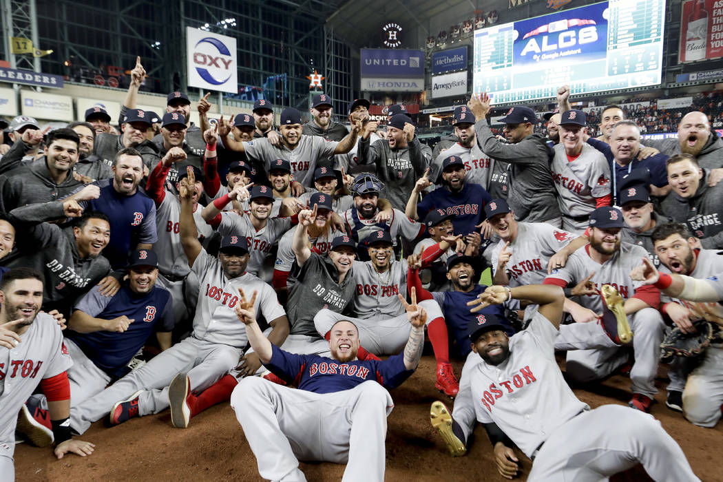 The Boston Red Sox pose for a picture after winning the baseball American League Championship Series against the Houston Astros on Thursday, Oct. 18, 2018, in Houston. Red Sox won 4-1. (AP Photo/D ...