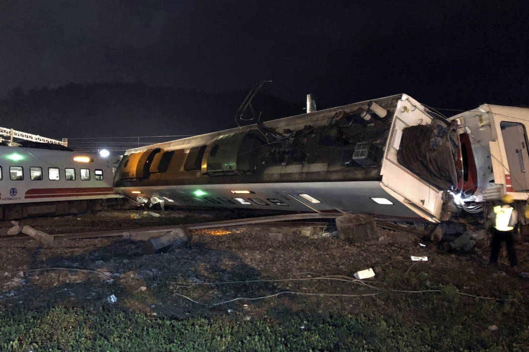 In this photo released by Taiwan Railways Administration, train carriages are scattered at the site of a train derailment in Lian in northern Taiwan on Sunday, Oct. 21, 2018. The Puyuma express tr ...
