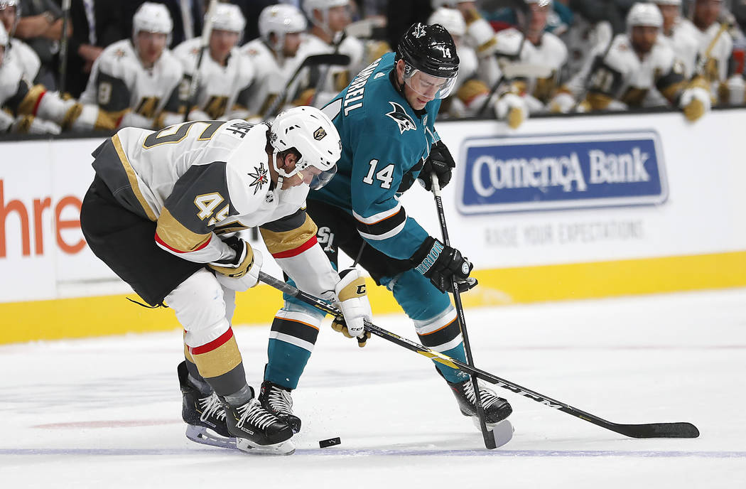 San Jose Sharks center Dylan Gambrell (14) and Vegas Golden Knights defenseman Jake Bischoff (45) vie for the puck during the second period of a preseason NHL hockey game in San Jose, Calif., Satu ...
