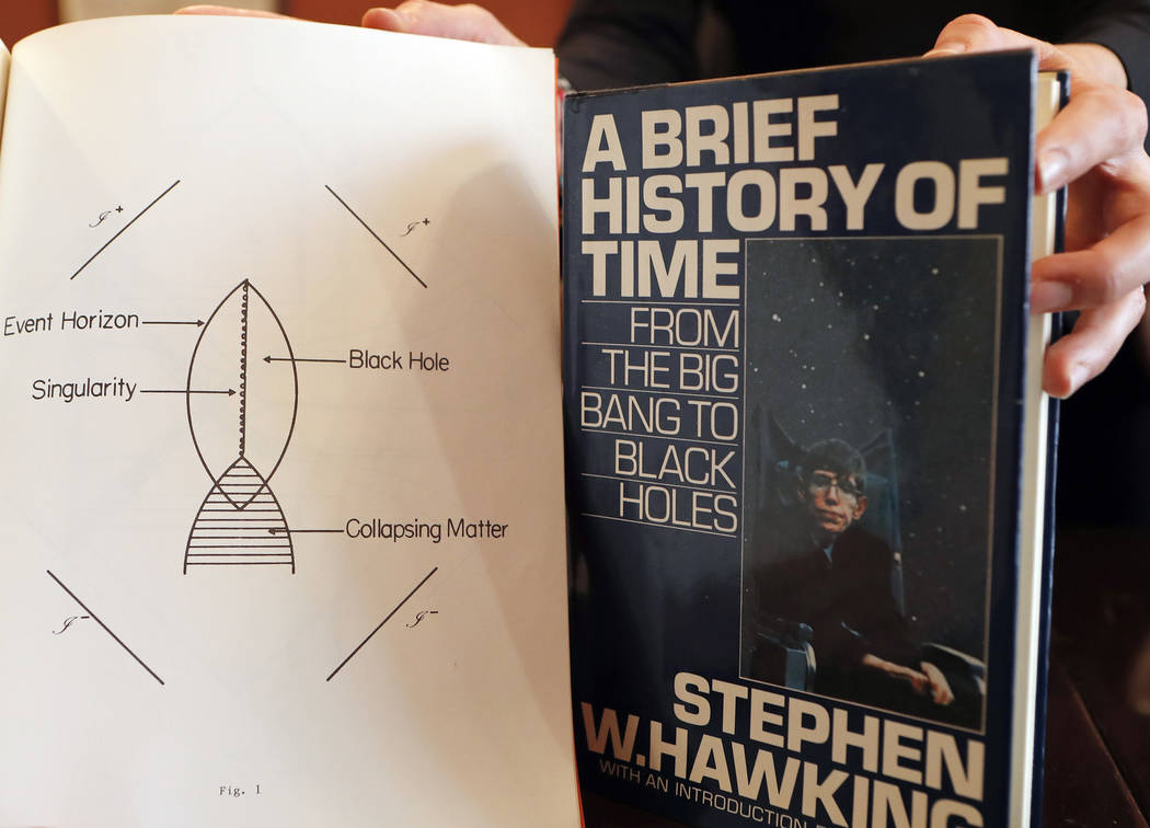 A Book, and scripts by Stephen Hawking are among the personal and academic possessions of Stephen Hawking at the auction house Christies in London, Friday, Oct. 19, 2018. (AP Photo/Frank Augstein)