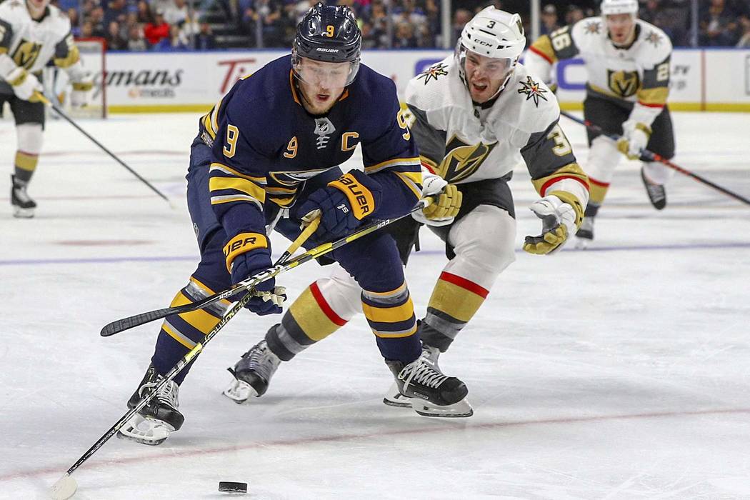 Buffalo Sabres center Jack Eichel (9) battles for the puck with Vegas Golden Knights defenseman Brayden McNabb (3) during the second period of play in an NHL hockey game between the Vegas Golden K ...