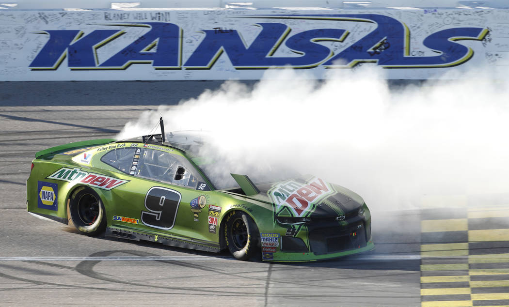 Chase Elliott (9) does a burnout after winning a NASCAR Cup Series auto race at Kansas Speedway in Kansas City, Kan., Sunday, Oct 21, 2018. (AP Photo/Colin E. Braley)