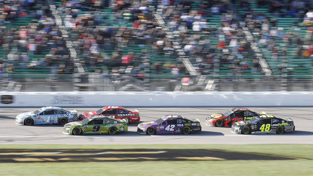 Kevin Harvick (4) leads with Chase Elliott (9) in second place at the start of the third stage during a NASCAR Cup Series auto race at Kansas Speedway in Kansas City, Kan., Sunday, Oct 21, 2018. E ...