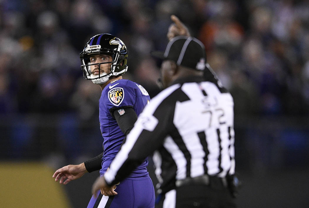 Baltimore Ravens kicker Justin Tucker, left, walks off the field after missing a point after attempt in the second half of an NFL football game against the New Orleans Saints, Sunday, Oct. 21, 201 ...