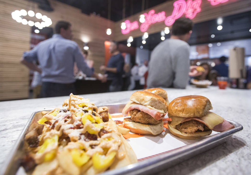 An order of Shaq Daddy sliders and Dirty Fries sits on the bar during the grand opening celebration of Big Chicken, Shaquille O'Neal's new fast-casual chicken restaurant located at 4480 Paradise R ...