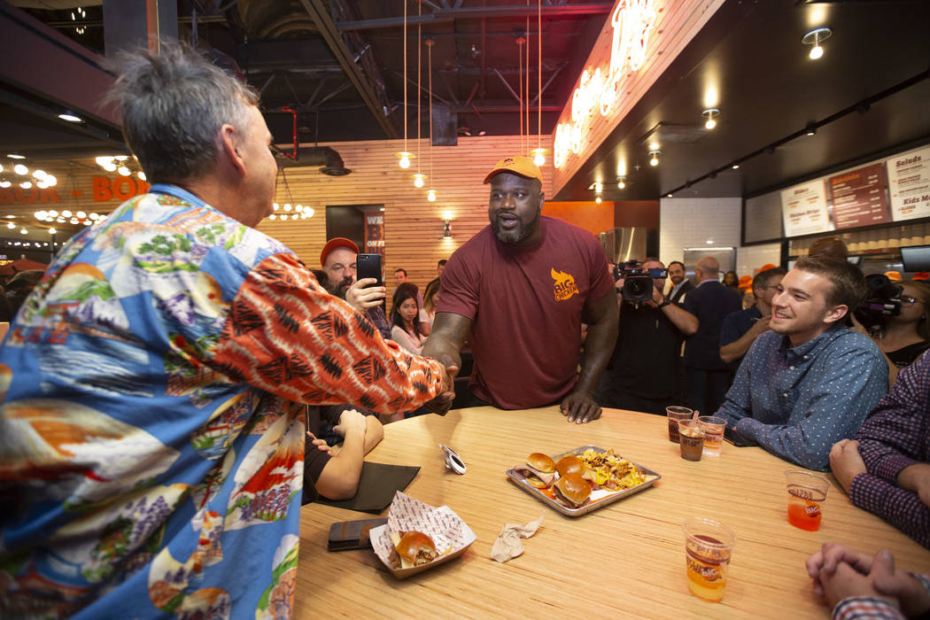 Retired NBA player Shaquille O'Neal, center, greets guests during the grand opening celebration of Big Chicken, Shaq's new fast-casual chicken restaurant located at 4480 Paradise Road in Las Vegas ...