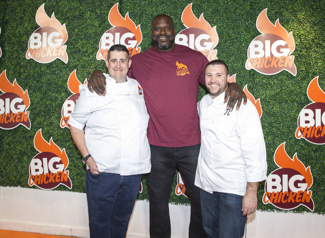 Retired NBA player Shaquille O'Neal poses with business partner Matthew Silverman, left, and vice president of culinary operations Matthew Piekarski during the grand opening celebration of Big Chi ...