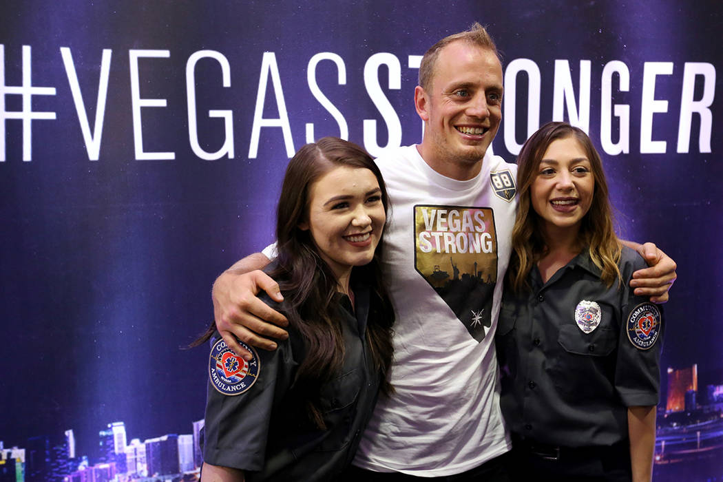 Vegas Golden Knights player Nate Schmidt (88) poses with Randi Sloan, left, and Kaitlyn Rogers during a ceremony honoring members of Community Ambulance "The 21" for their courage under fire, exce ...