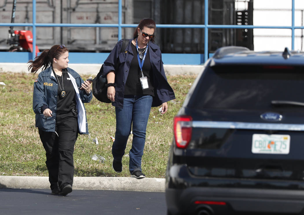 Postal inspectors leave a postal facility, Friday, Oct. 26, 2018, in Opa-Locka, Fla.A law enforcement official has confirmed to The Associated Press that the suspicious package addressed to New Je ...