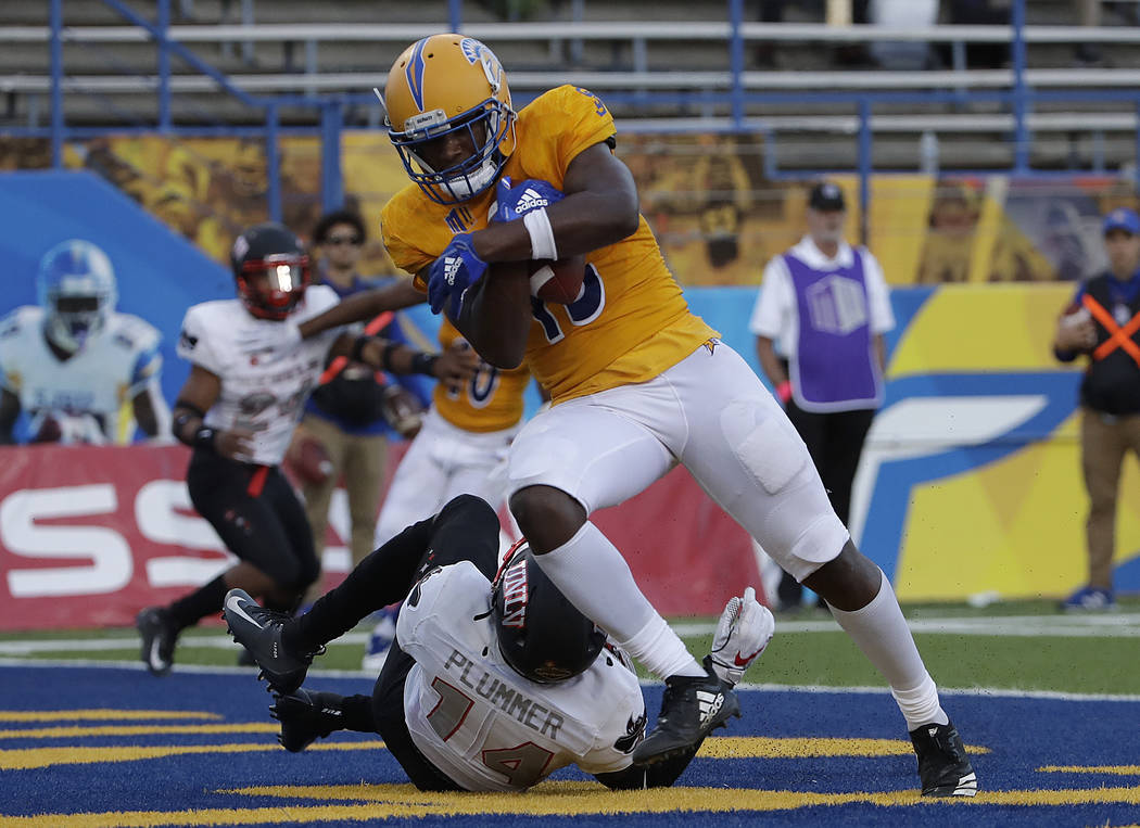 San Jose State wide receiver Tre Hartley, top, scores a touchdown against UNLV defensive back Myles Plummer (14) during the second half of an NCAA college football game in San Jose, Calif., Saturd ...