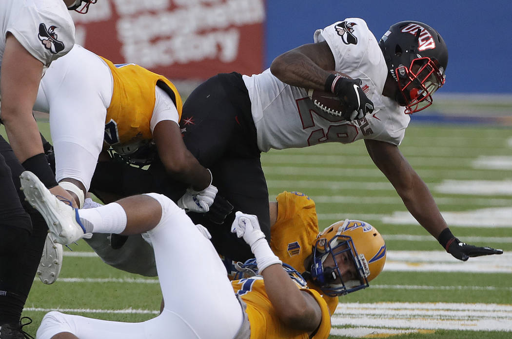 UNLV running back Evan Owens, top, is tackled against San Jose State during the second half of an NCAA college football game in San Jose, Calif., Saturday, Oct. 27, 2018. (AP Photo/Jeff Chiu)