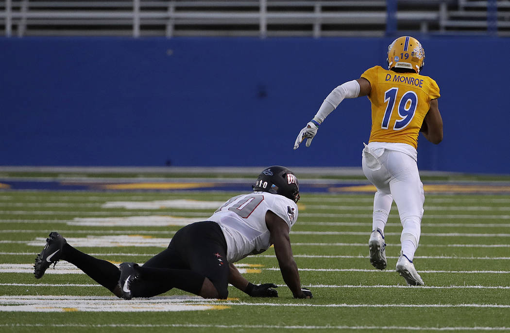 UNLV wide receiver Darren Woods Jr., left, watches as San Jose State cornerback Dakari Monroe (19) returns an interception for a touchdown during the second half of an NCAA college football game i ...