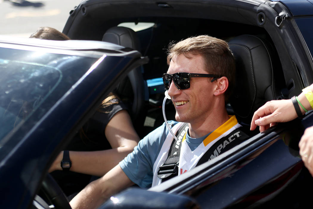 Bradley Boe reacts after driving a car at an event for Driven, a new rehabilitation center to help people with disabilities that will be built in downtown Las Vegas at SpeedVegas in Las Vegas, Sun ...