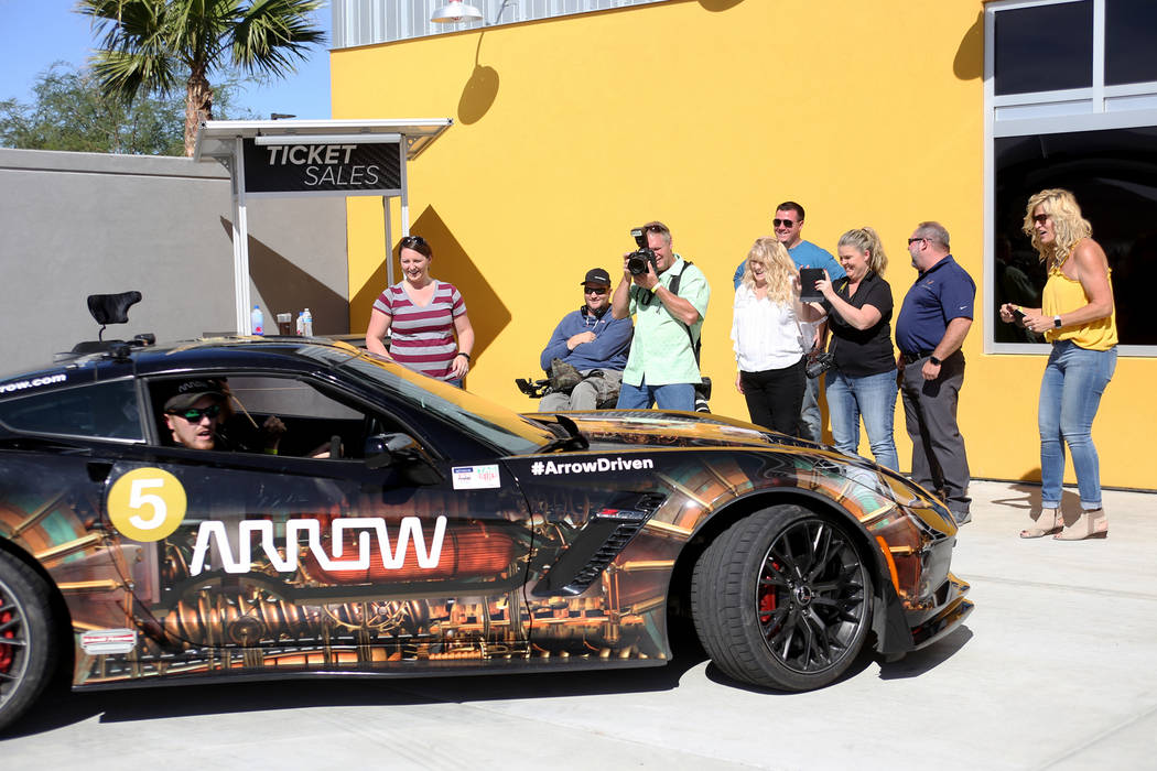 Friends and family watch Corey Capece drive away at an event for Driven, a new rehabilitation center to help people with disabilities that will be built in downtown Las Vegas at SpeedVegas in Las ...