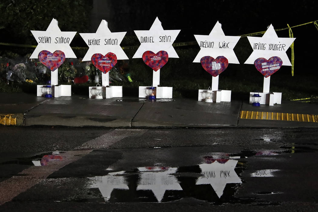 These Stars of David with the names of five of the 11 people killed at the Tree of Life Synagogue part of a memorial of flowers and stars that have collected outside the temple, Sunday, Oct. 28, 2 ...
