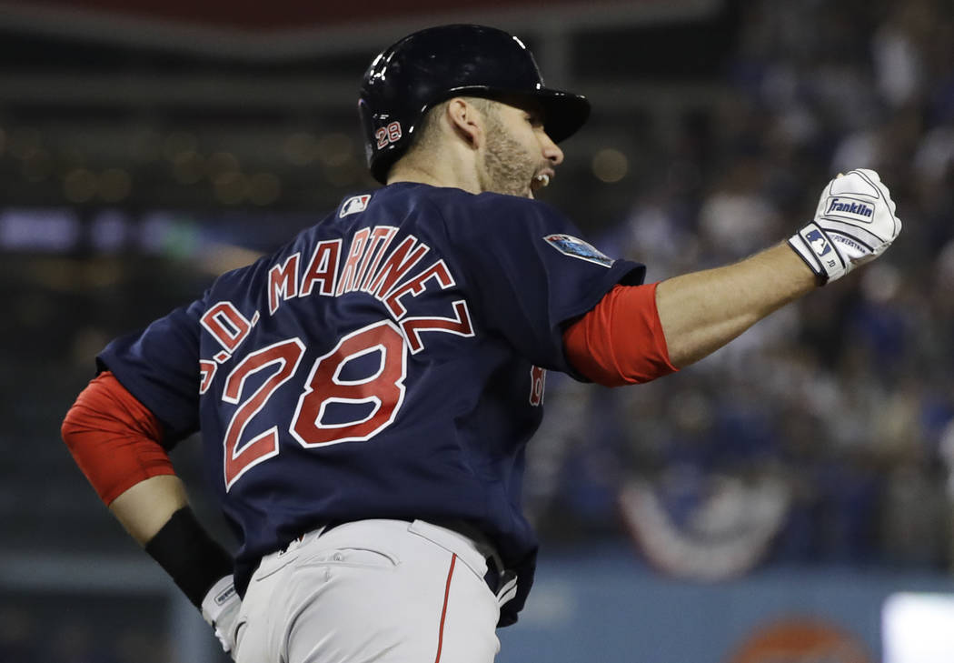 Boston Red Sox's J.D. Martinez celebrates after hitting a solo home run  against Los Angeles Dodgers' Clayton Kershaw during the seventh inning in  Game 5 of the World Series baseball game on