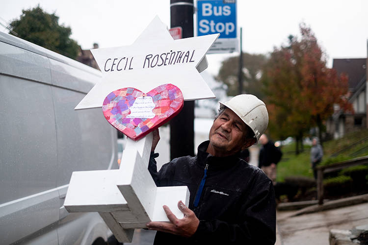 Greg Zanis carries a wooden marker with the name Cecil Rosenthal on it. After the tragic shooting in Pittsburgh, PA at the Tree of Life. Community gathers from all different races and religions. ...
