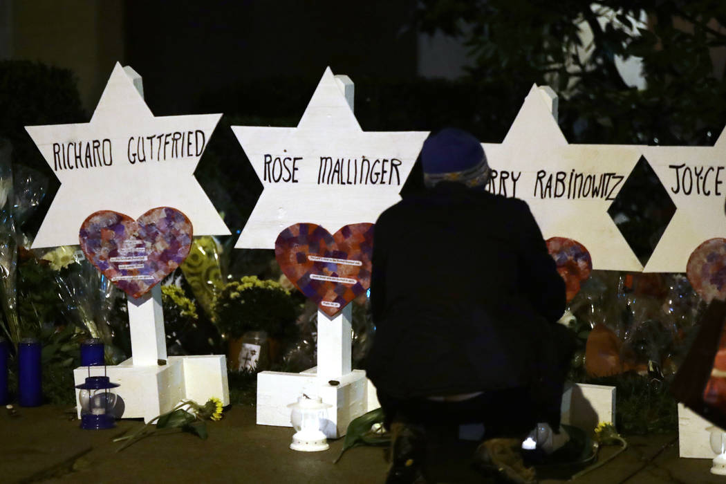 Stars of David with the names of those killed in a deadly shooting at the Tree of Life Synagogue stand in front of the synagogue in Pittsburgh, Sunday, Oct. 28, 2018. (AP Photo/Matt Rourke)