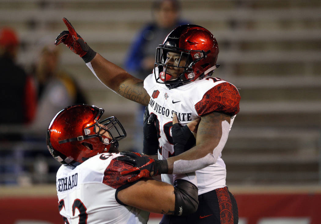 San Diego State running back Juwan Washington, right, celebrates with teammate Nick Gerhard after scoring a touchdown during the second half of an NCAA college football game in Albuquerque, N.M., ...