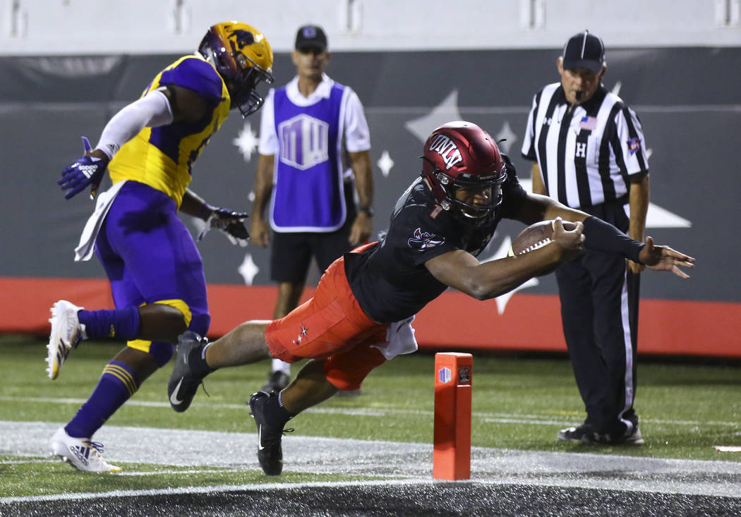 UNLV Rebels quarterback Armani Rogers (1) dives to score a touchdown past Prairie View A&M Panthers linebacker Isaac Claiborne (59) during the second half of a football game at Sam Boyd Stadiu ...