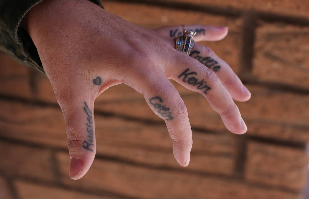 Meredith Tracy shows the tattoos of her husband's and childrens' names on her hand at the Las Vegas Review-Journal in Las Vegas, Wednesday, Oct. 31, 2018. Her husband, Russell Tracy, died more tha ...