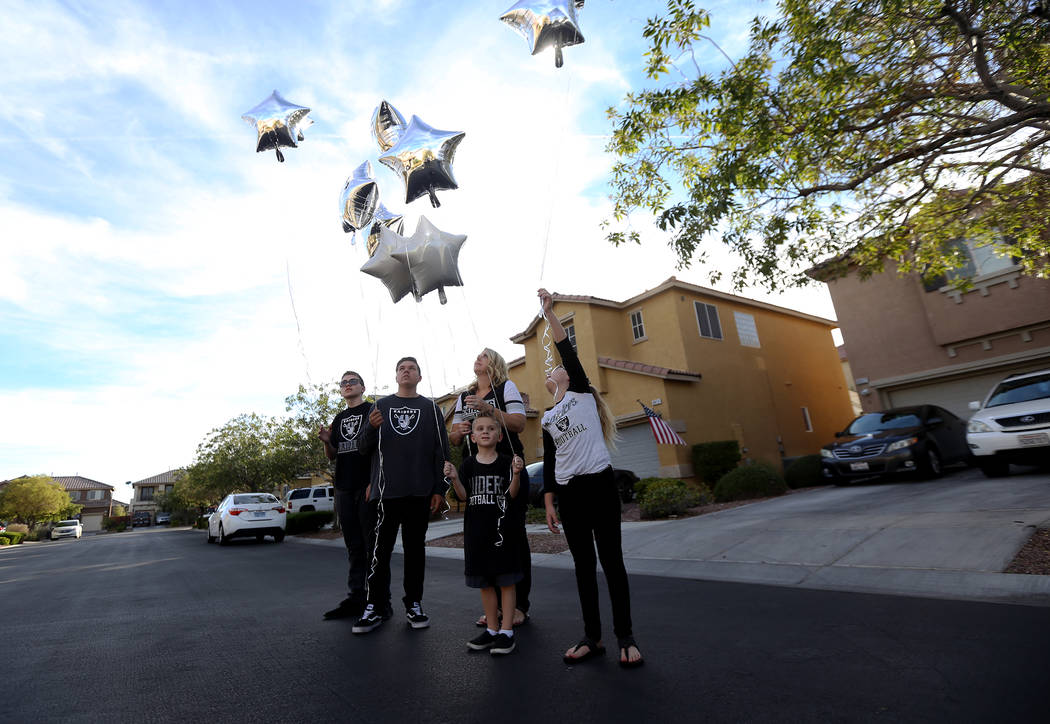 The Tracy family, from left, Kevin Tracy, 14, Colin Tracy, 17, Meredith Tracy, Callie Tracy, 9, and Kannon Tracy, 5, release balloons in honor of Russell Tracy's birthday outside their home in Las ...