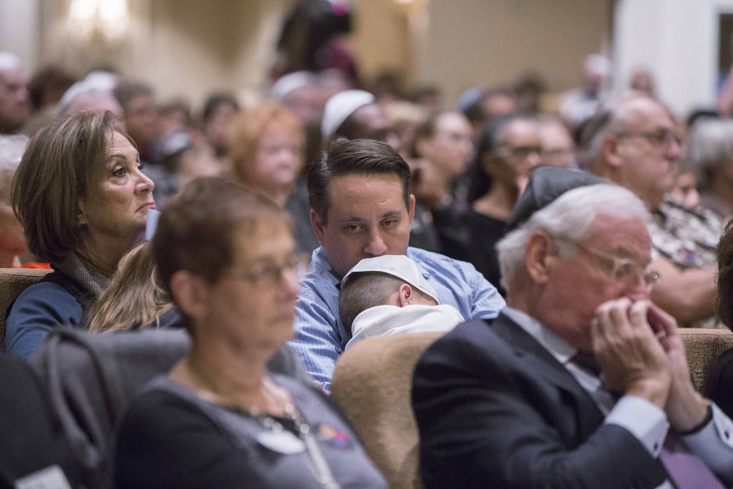 Attendees listen to a speaker during a vigil on Thursday, November 1, 2018, at Temple Beth Sholom in Las Vegas for the 11 people killed at the Tree of Life synagogue in Pittsburgh, Pa., on Saturda ...