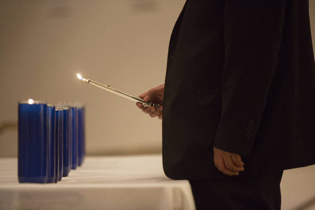 Eleven candles are lit during a vigil on Thursday, November 1, 2018, at Temple Beth Sholom in Las Vegas for the 11 people killed at the Tree of Life synagogue in Pittsburgh, Pa., on Saturday. Benj ...