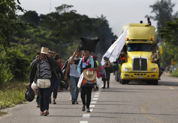 Central American migrants, part of the caravan hoping to reach the U.S. border, begin their morning trek, in Donaji, Oaxaca state, Mexico, Friday, Nov. 2, 2018. The migrants had already made a gru ...
