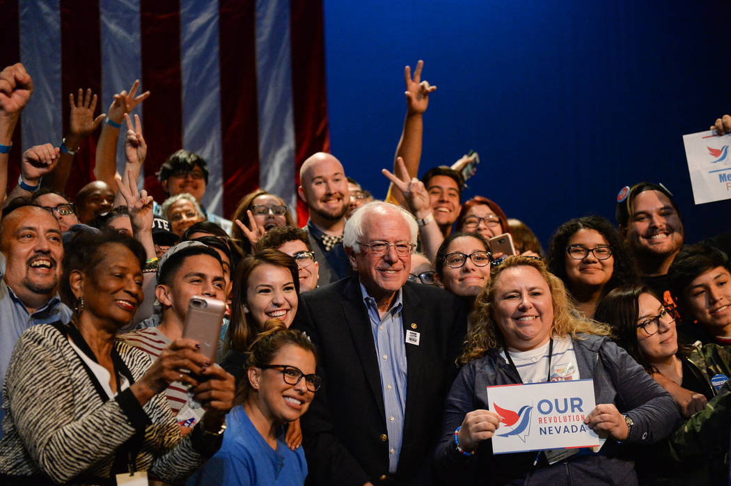 U.S. Sen. Bernie Sanders poses for a photograph with people gathered at the Las Vegas Academy of the Arts as he continues his nine-state swing this week to help boost progressive candidates up and ...