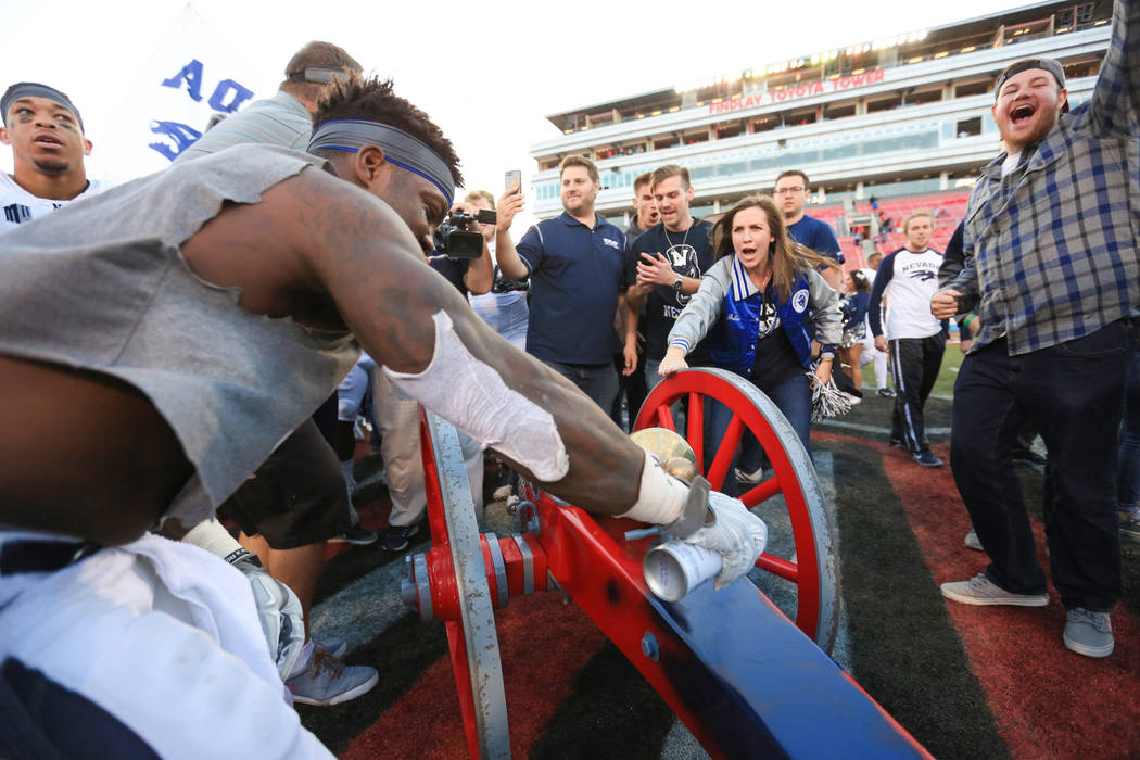 Nevada Wolf Pack running back James Butler (20) paints the Fremont Cannon blue after the Nevada Wolf Pack beat UNLV 45-10 at Sam Boyd Stadium in Las Vegas on Saturday, Nov. 26, 2016. Brett Le Blan ...
