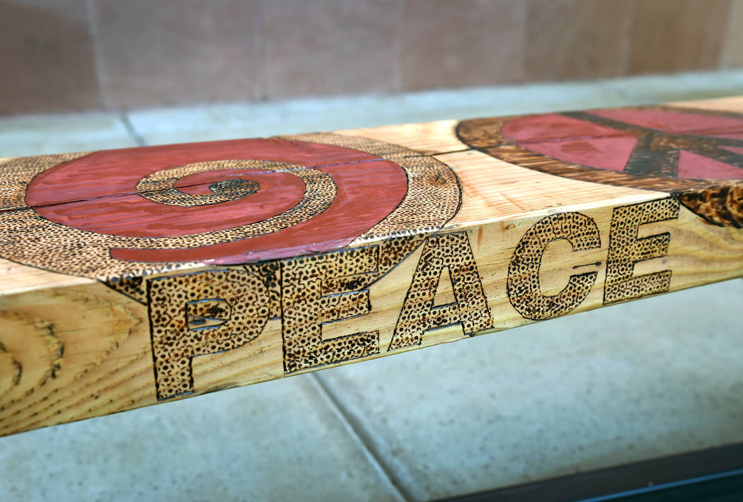 The "Peace" bench is displayed after its unveiling at the Henderson City Hall Thursday, Nov. 1, 2018, in Henderson. The wooden bench designed by artist Justin Lepper and woodworker Kerm Sablan eve ...