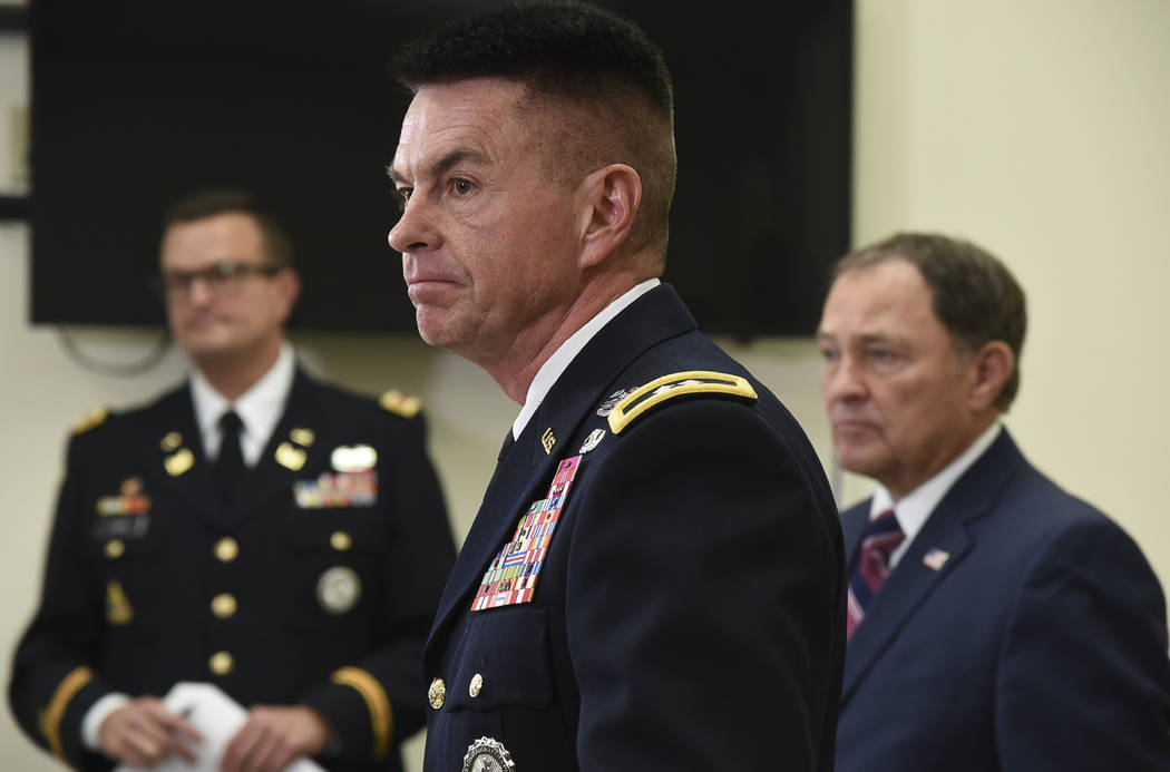 Maj. Gen. Jefferson S. Burton, center, address the media on Sunday, Nov. 4, 2018, in Draper, Utah, about the death of Maj. Brent Taylor, the mayor of a city north of Salt Lake City who was killed ...