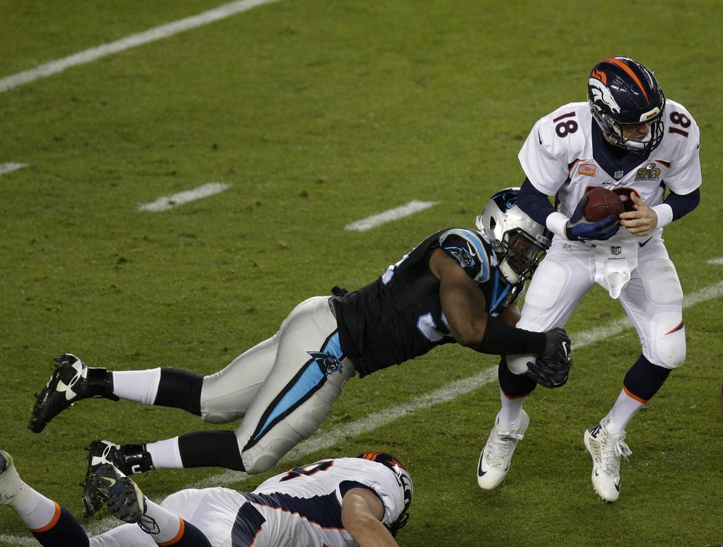 Carolina Panthers Kony Ealy (94) sacks Denver Broncos Peyton Manning (18) during the second half of the NFL Super Bowl 50 football game Sunday, Feb. 7, 2016, in Santa Clara, Calif. (AP Photo/Charl ...