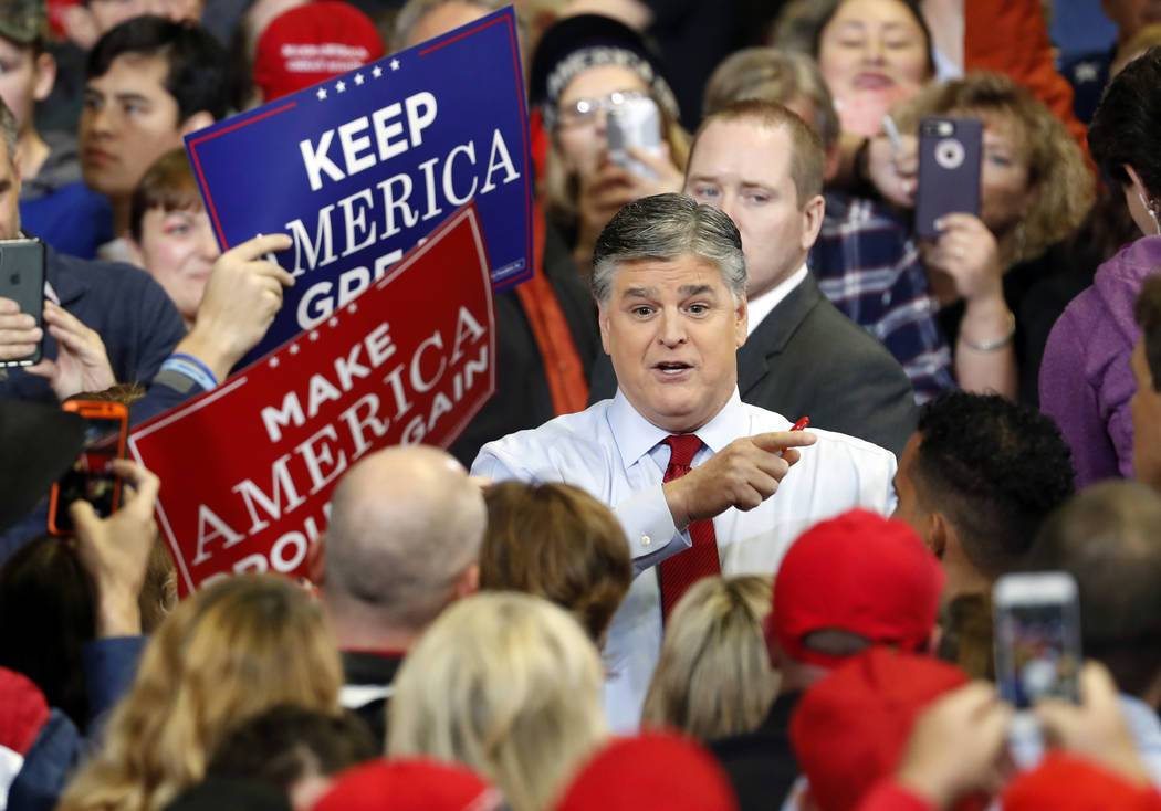 Television personality Sean Hannity speaks to members of the audience while signing autographs before the start of a campaign rally Monday, Nov. 5, 2018, in Cape Girardeau, Mo., with President Don ...
